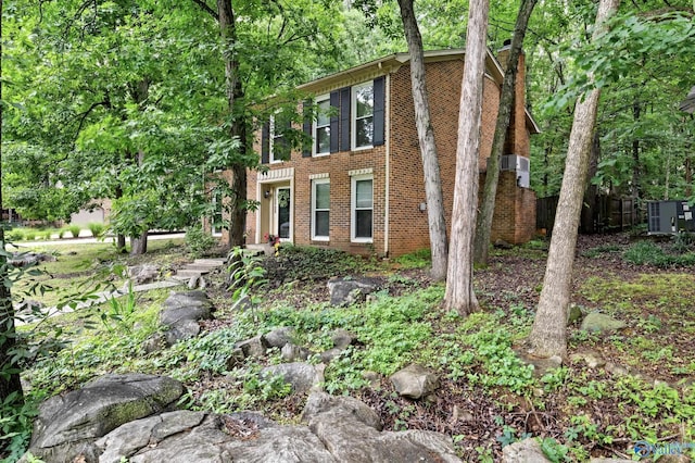 view of front of property featuring brick siding and a chimney