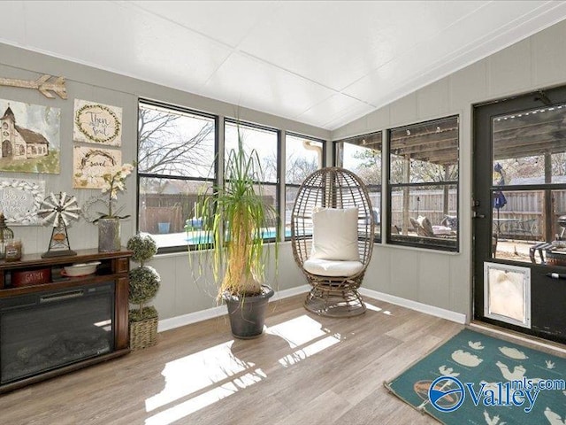 sunroom / solarium featuring lofted ceiling