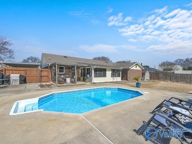 view of swimming pool with a fenced in pool, a patio, area for grilling, and a fenced backyard