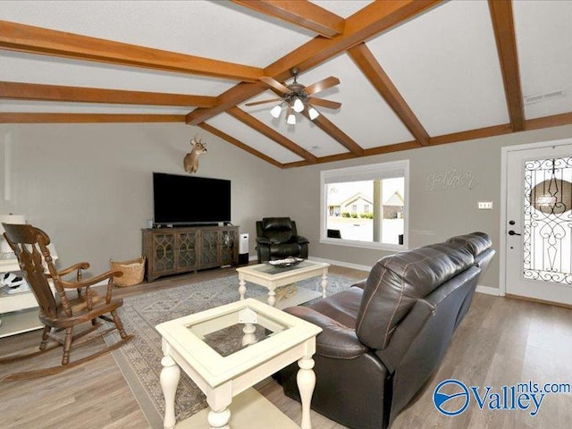 living area featuring lofted ceiling with beams, baseboards, light wood-style floors, and a ceiling fan