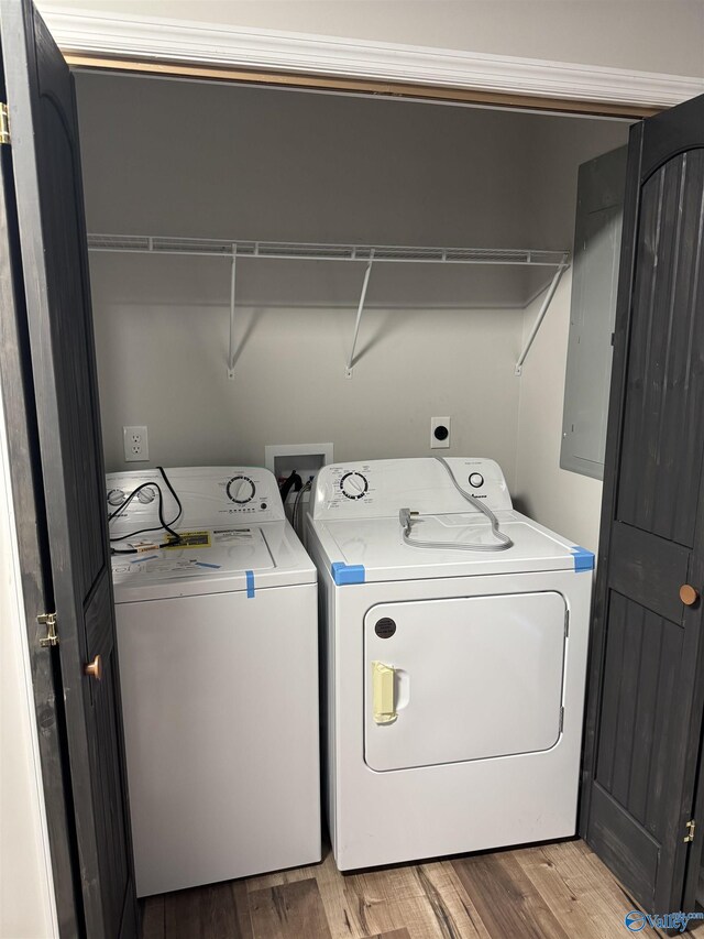 laundry area with laundry area, light wood-style floors, and washer and clothes dryer