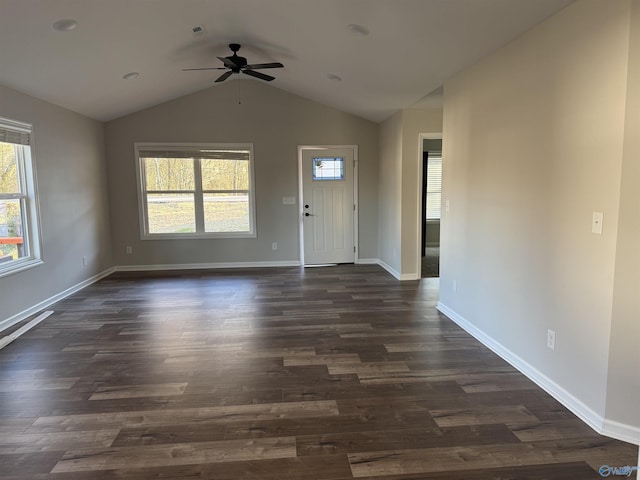 interior space with baseboards, ceiling fan, and dark wood finished floors