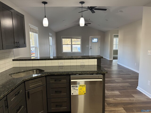 kitchen featuring dark wood-style flooring, backsplash, hanging light fixtures, ceiling fan, and a peninsula