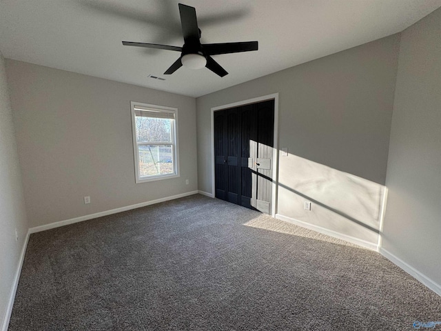 unfurnished bedroom with baseboards, visible vents, carpet, and a ceiling fan