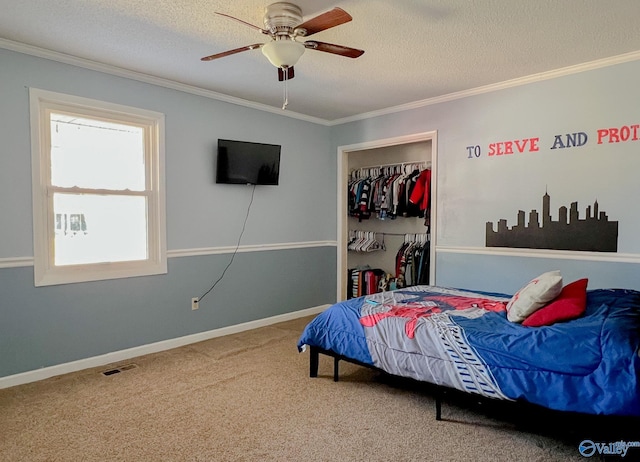 carpeted bedroom featuring a textured ceiling, visible vents, baseboards, a closet, and crown molding