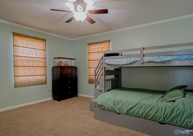 bedroom featuring light colored carpet, ornamental molding, ceiling fan, a textured ceiling, and baseboards