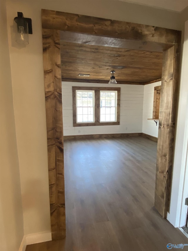 spare room with dark hardwood / wood-style floors and wooden ceiling