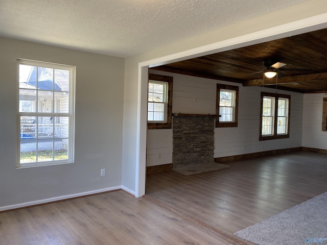 unfurnished room featuring hardwood / wood-style flooring, a wealth of natural light, and a textured ceiling