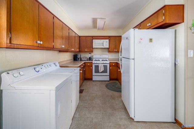 kitchen featuring washer and dryer and white appliances