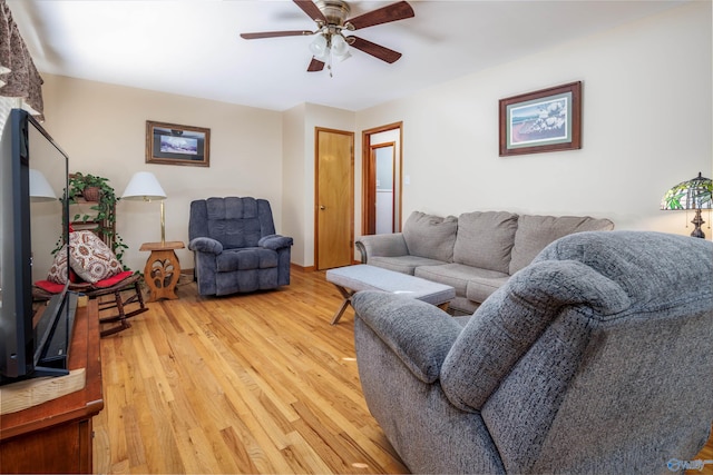 living room featuring hardwood / wood-style floors and ceiling fan