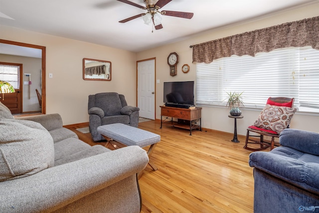 living room with light hardwood / wood-style floors and ceiling fan