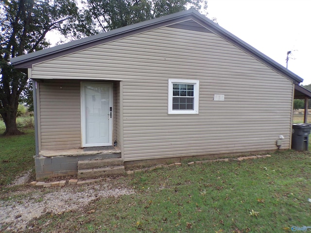 rear view of property featuring a yard