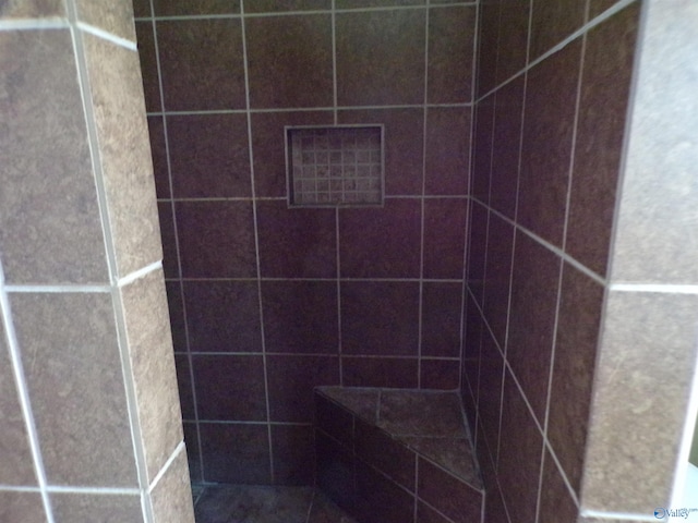 bathroom with tiled shower