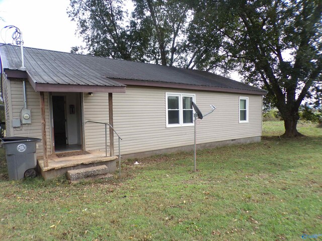 rear view of property with a lawn