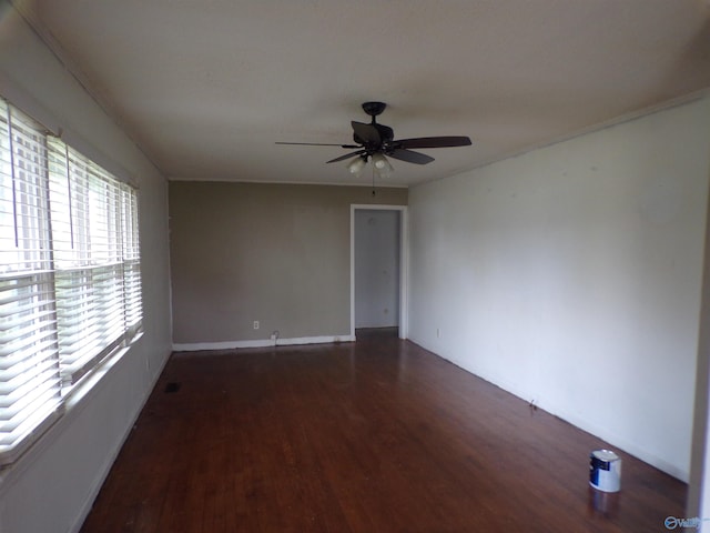 spare room with dark hardwood / wood-style flooring and ceiling fan