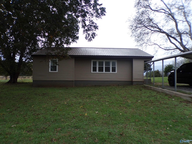 view of side of home with a yard