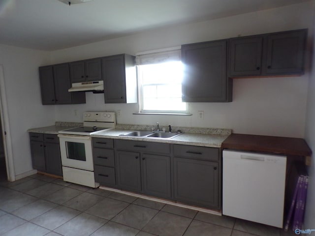 kitchen featuring white appliances, sink, light tile patterned flooring, and gray cabinets