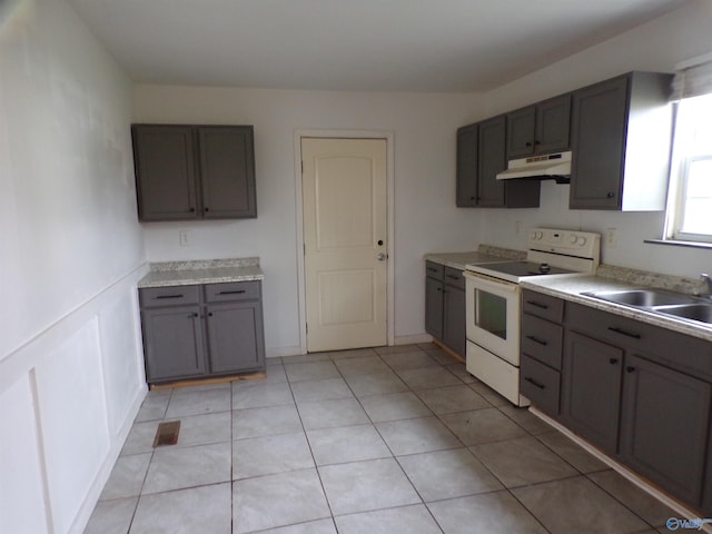 kitchen featuring sink, white electric range oven, and light tile patterned floors