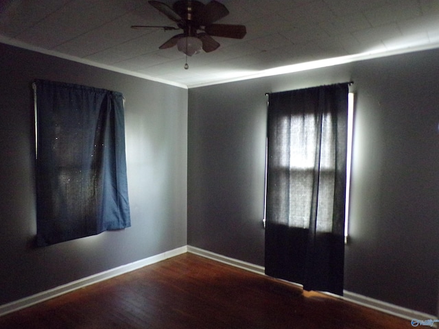 unfurnished room featuring ceiling fan and dark hardwood / wood-style flooring