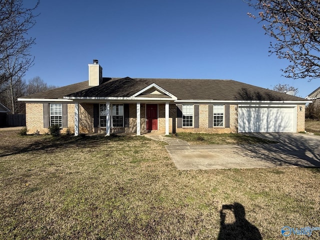 ranch-style home featuring driveway, a front yard, a garage, brick siding, and a chimney