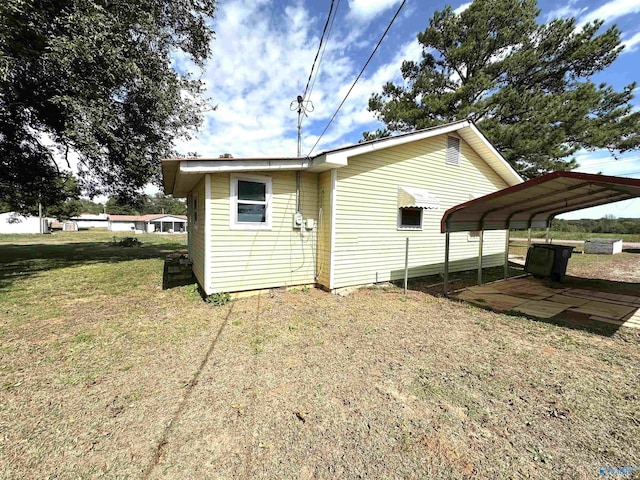 view of property exterior featuring a detached carport and a yard