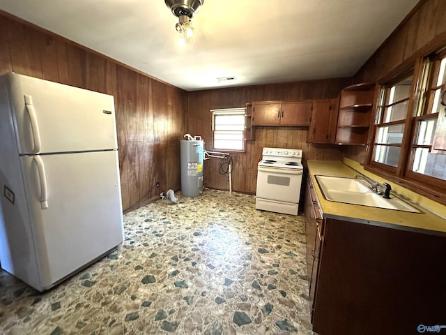 kitchen featuring open shelves, a sink, wooden walls, water heater, and white appliances