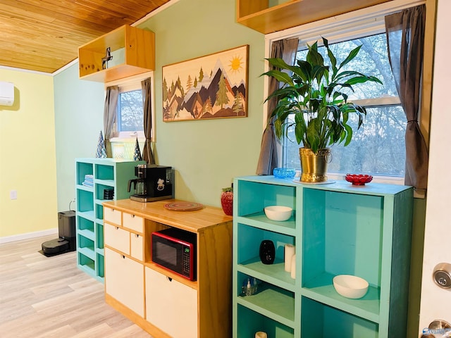 game room with light wood finished floors, wood ceiling, a wealth of natural light, and a wall mounted air conditioner