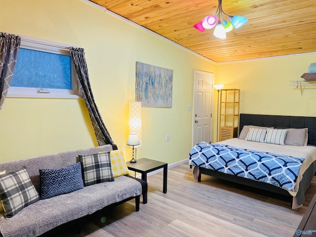 bedroom featuring wooden ceiling, wood finished floors, and baseboards