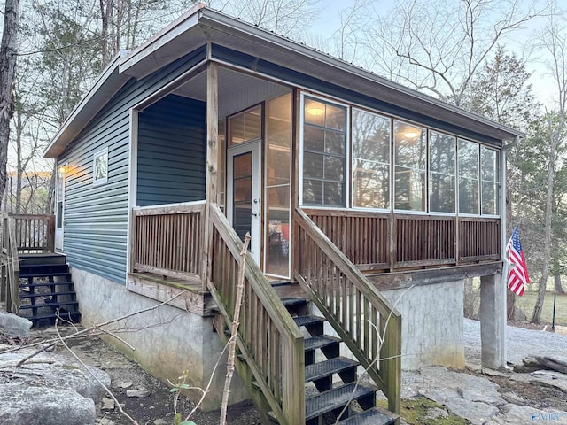 exterior space with stairway and a sunroom