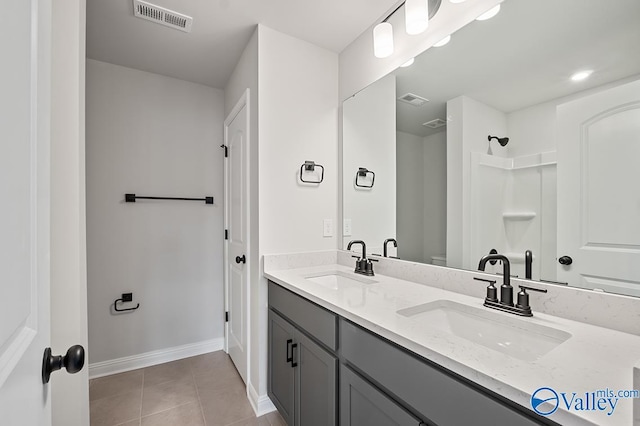 bathroom with tile patterned flooring and vanity