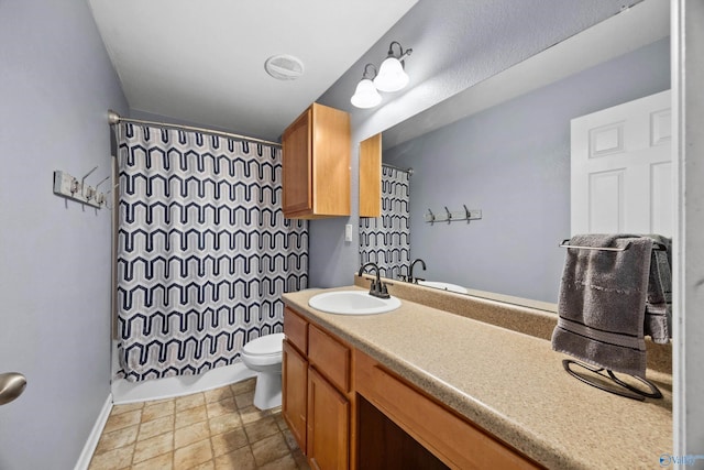 full bathroom with vanity, shower / bath combo, and toilet