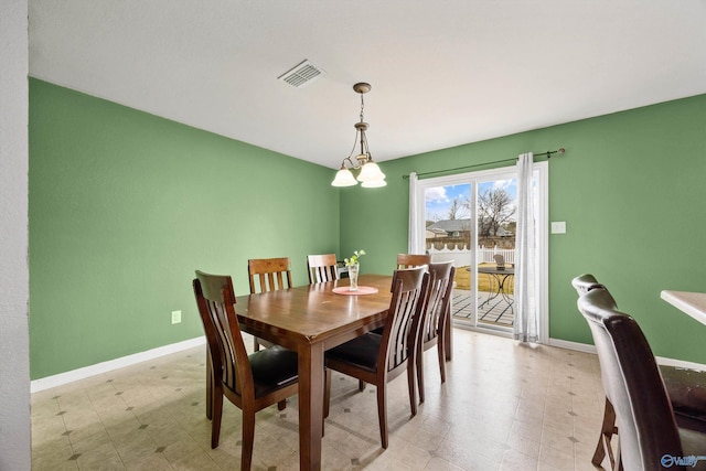 dining space featuring a notable chandelier