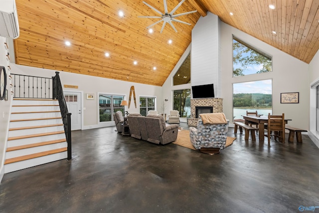 living room featuring high vaulted ceiling, a fireplace, a wall mounted AC, wood ceiling, and beam ceiling