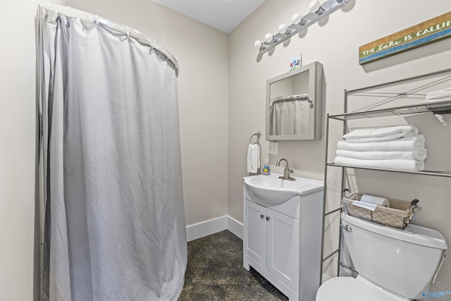 bathroom with vanity, concrete floors, and toilet