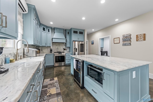 kitchen featuring sink, stainless steel appliances, a kitchen island, custom exhaust hood, and beverage cooler