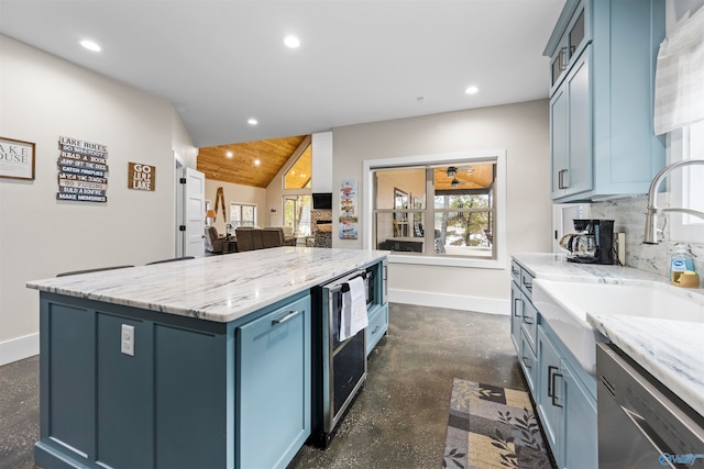 kitchen featuring a center island, stainless steel dishwasher, beverage cooler, and blue cabinetry