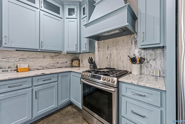 kitchen featuring appliances with stainless steel finishes, light stone countertops, custom range hood, and backsplash