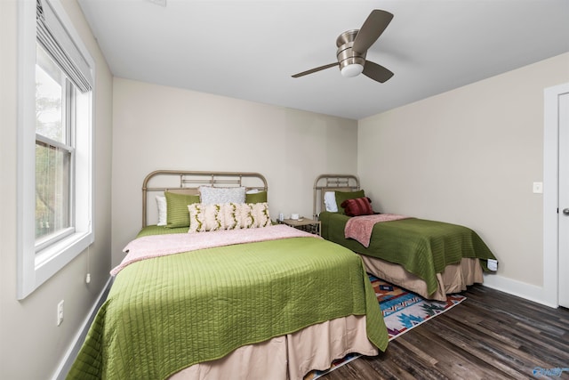 bedroom with dark hardwood / wood-style floors and ceiling fan