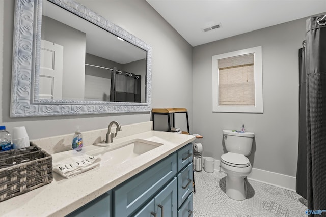 bathroom with vanity, curtained shower, tile patterned floors, and toilet