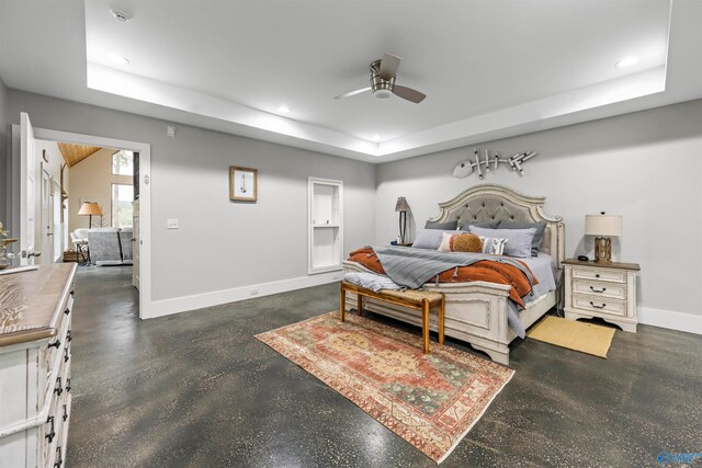 bedroom featuring a raised ceiling and ceiling fan