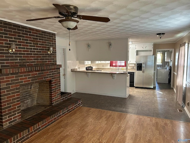 kitchen with white cabinetry, a kitchen breakfast bar, stainless steel fridge with ice dispenser, kitchen peninsula, and wood-type flooring