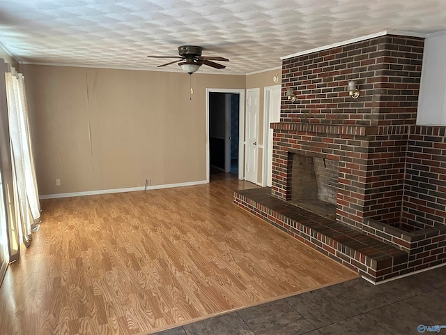 unfurnished living room featuring a fireplace, wood-type flooring, a textured ceiling, and ceiling fan