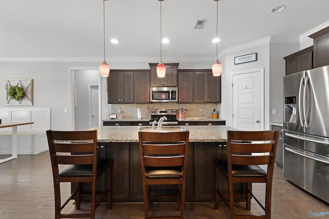 kitchen featuring dark brown cabinets, decorative backsplash, crown molding, and stainless steel appliances