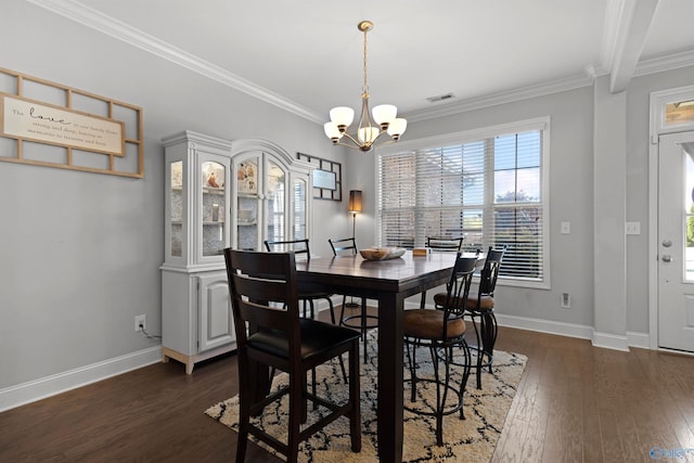 dining area with dark wood-type flooring, ornamental molding, visible vents, a notable chandelier, and baseboards