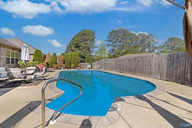 view of swimming pool featuring a fenced backyard, a fenced in pool, and a patio