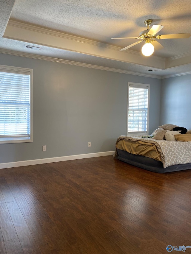 unfurnished bedroom featuring dark wood-type flooring, ceiling fan, and ornamental molding