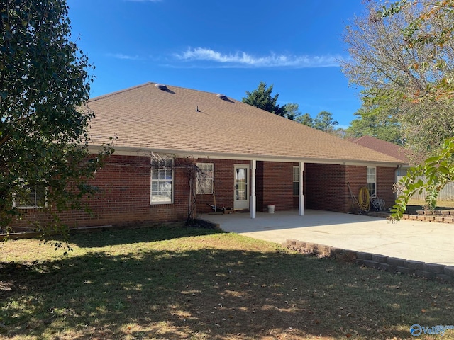 rear view of property with a lawn and a patio area