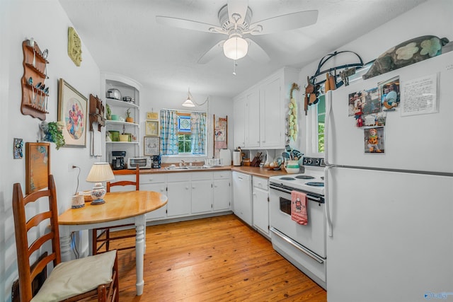 kitchen featuring white appliances, ceiling fan, light wood finished floors, a sink, and white cabinetry