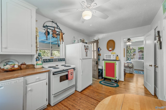 kitchen with ceiling fan, white appliances, light wood-style flooring, and white cabinets