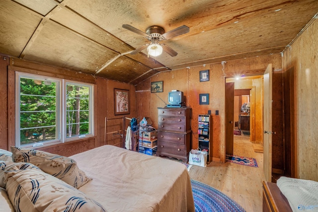 bedroom featuring wood walls, wood finished floors, lofted ceiling, and wood ceiling